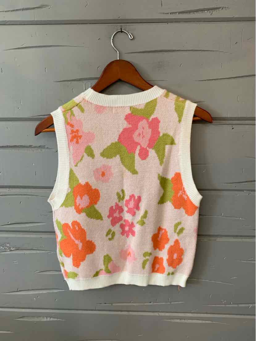 Sleeveless knit vest with pink, orange, and green floral pattern on white background, size large.