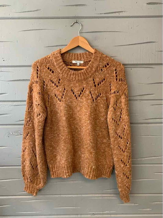 Tan marled knit sweater with openwork diamond patterns and ribbed cuffs and hem.