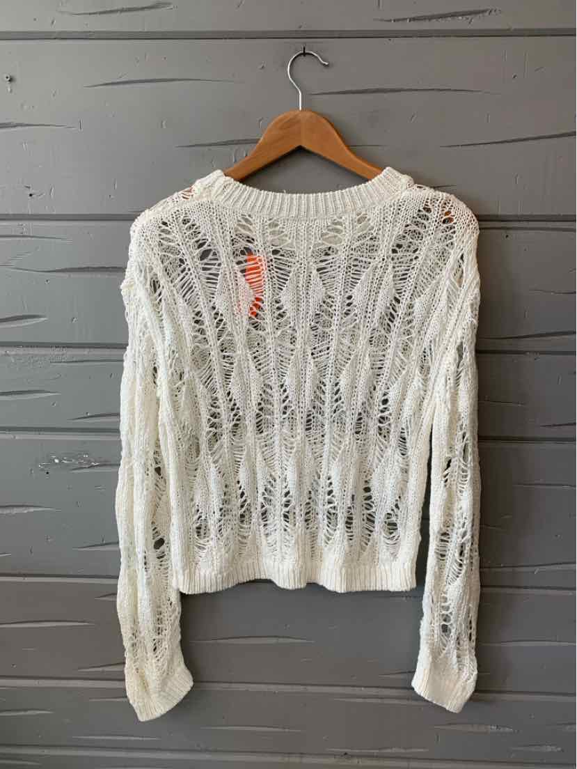 White open-knit long-sleeve sweater with loose, airy cable patterns and ribbed cuffs.