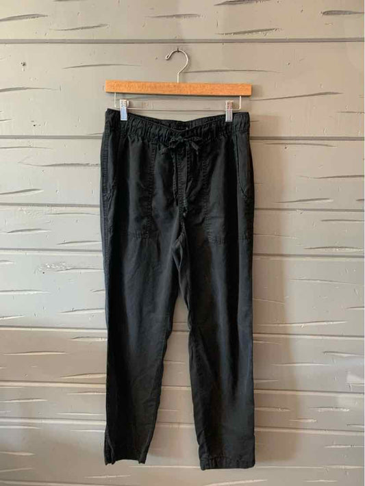 Black mid-rise straight-leg pants with an elastic waistband and adjustable drawstring.