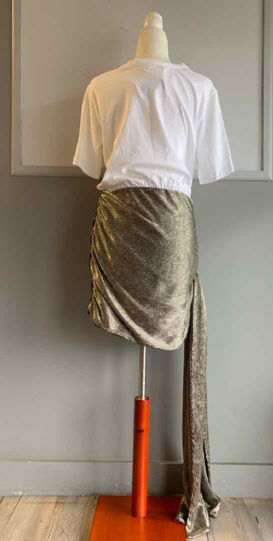 White cropped short-sleeve top paired with a ruched beige skirt featuring a long side tie detail.