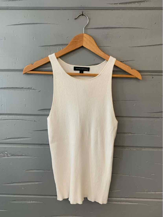 White ribbed sleeveless tank top with scoop neckline on wooden hanger.