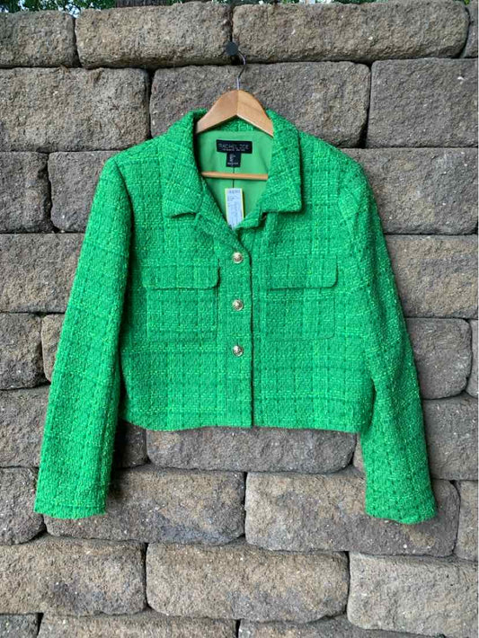 Green tweed cropped blazer with long sleeves and front flap pockets.