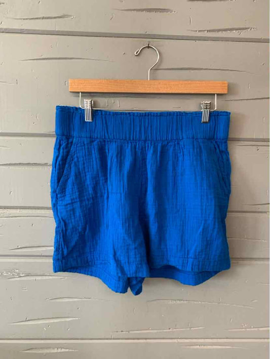 Bright blue casual shorts with elastic waistband and side pockets, lightweight fabric.