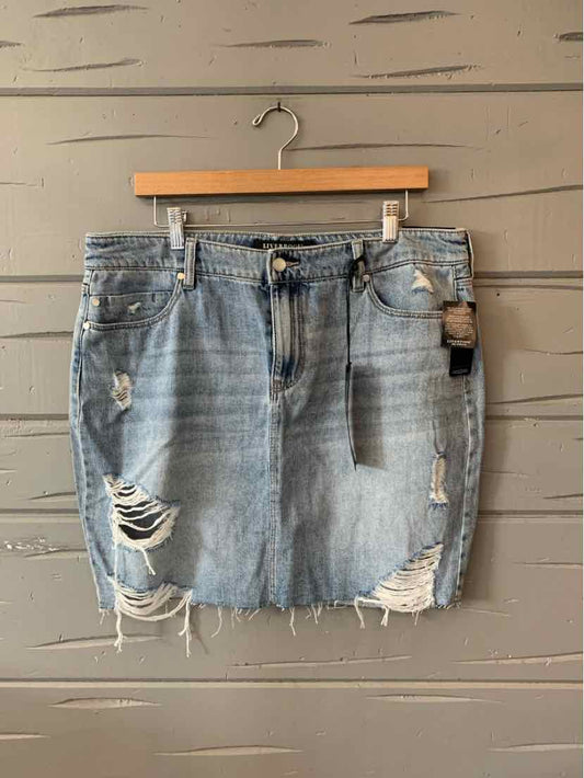 Light blue distressed denim skirt with frayed hem and front pockets, size 12.