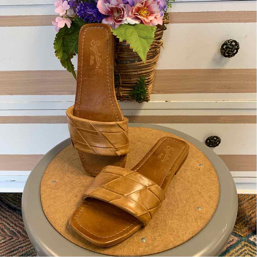 Tan woven leather slide sandals with square toes and flat soles, size 8.5.