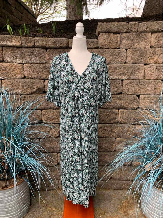 Floral print midi dress in green, white, and black with short sleeves and V-neckline.