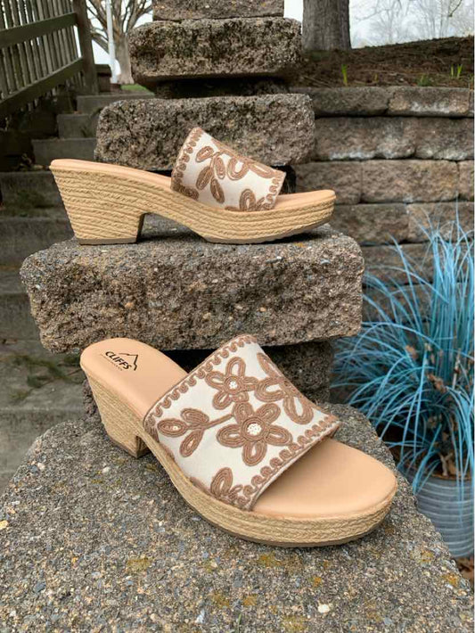 Beige wedge sandals with brown floral embroidery and woven platform soles, size 9.