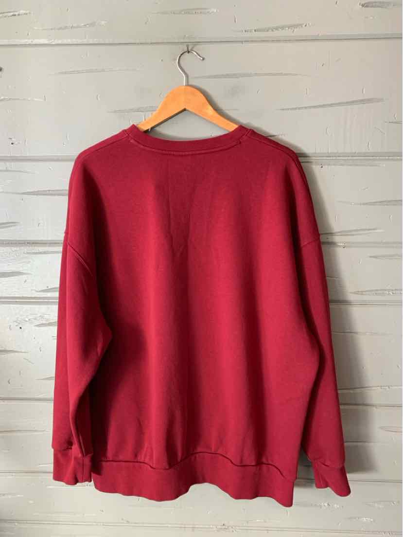 Solid burgundy Under Armour crewneck sweatshirt with long sleeves and ribbed cuffs and hem, size XL.