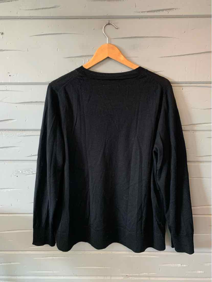 Black long-sleeve crewneck shirt in size XL with a simple solid design hanging on wooden hanger.