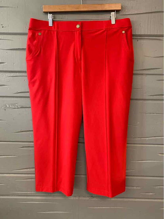 Red straight-leg pants with front pockets and belt loops, size 16/18, hanging on wooden hanger.