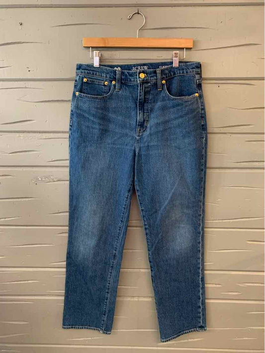 Blue high-waisted slim-fit denim jeans with front pockets and button closure.