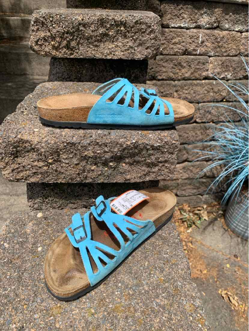 Women's size 38 Birkenstock sandals in bright blue with dual adjustable straps and cork footbed.