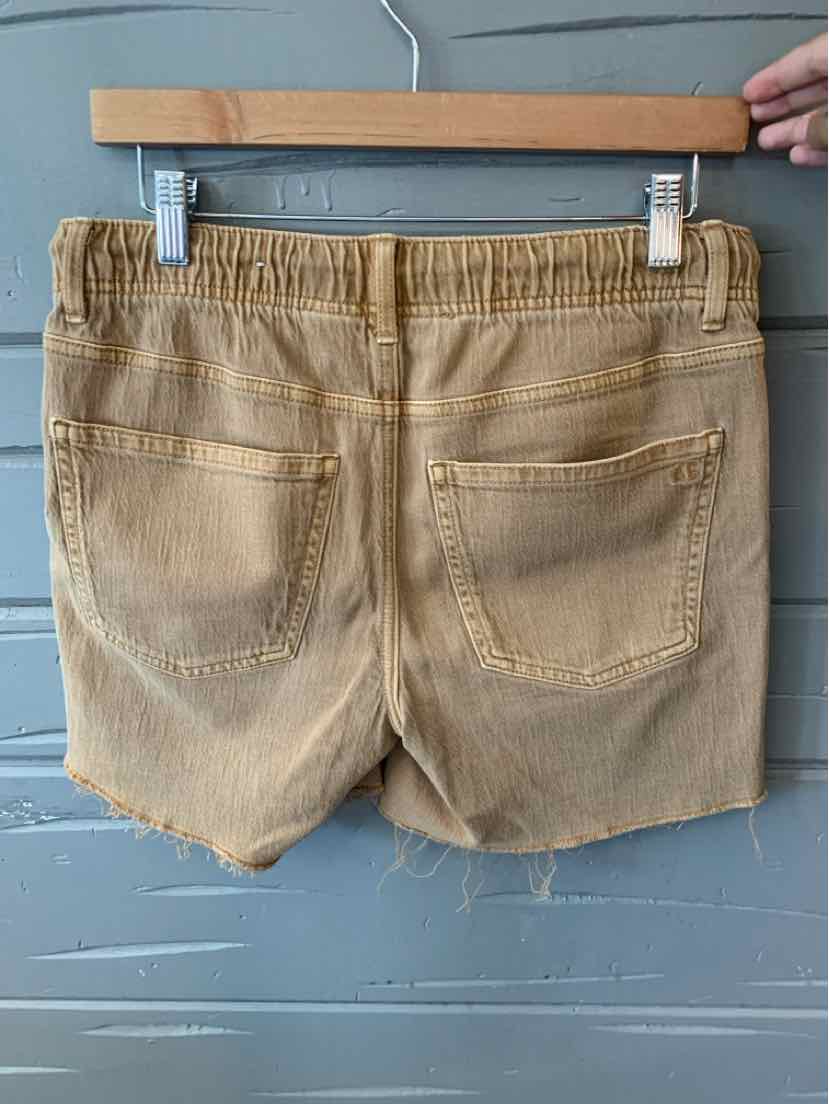 Tan denim shorts with frayed hem and two back pockets on wooden hanger.