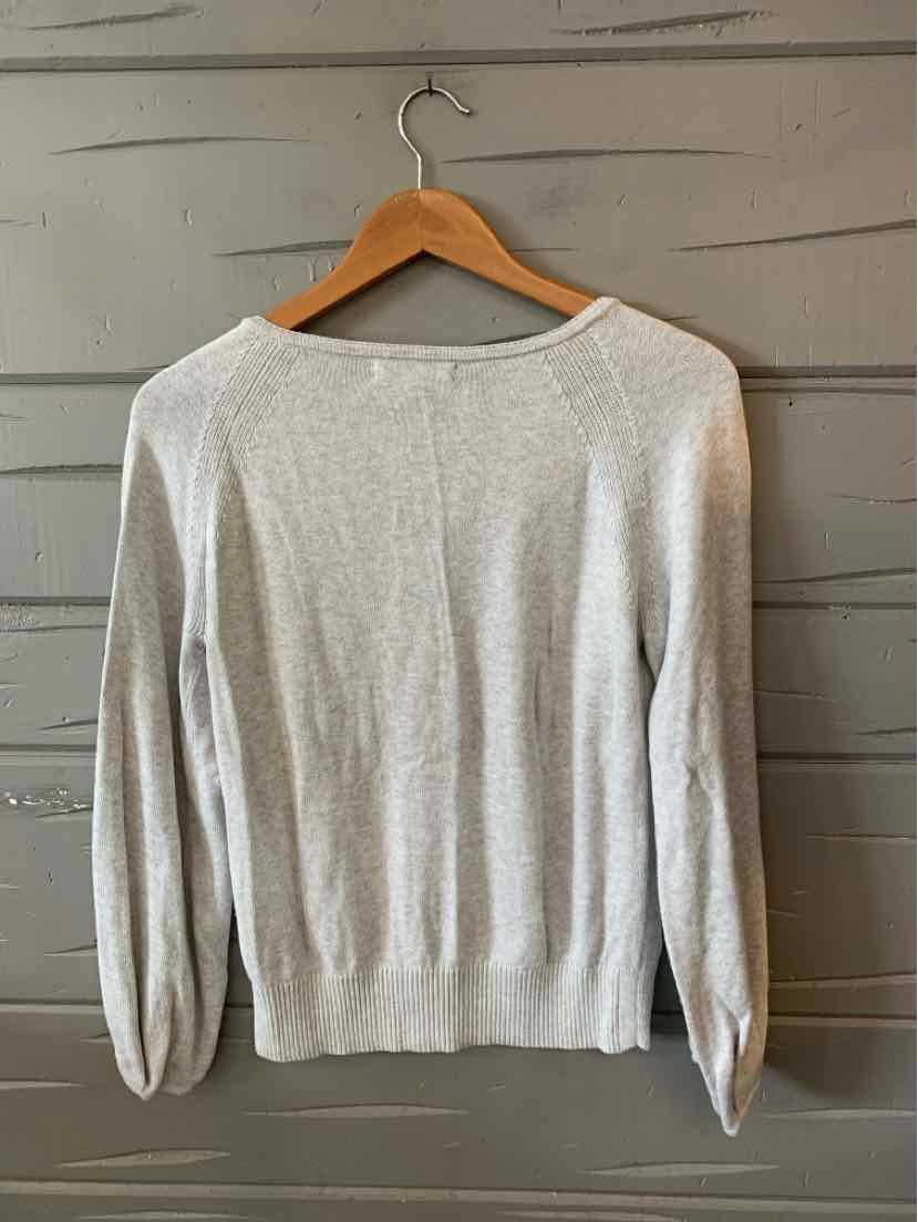 Light gray long-sleeve knit sweater with a crew neckline and ribbed cuffs and hem.