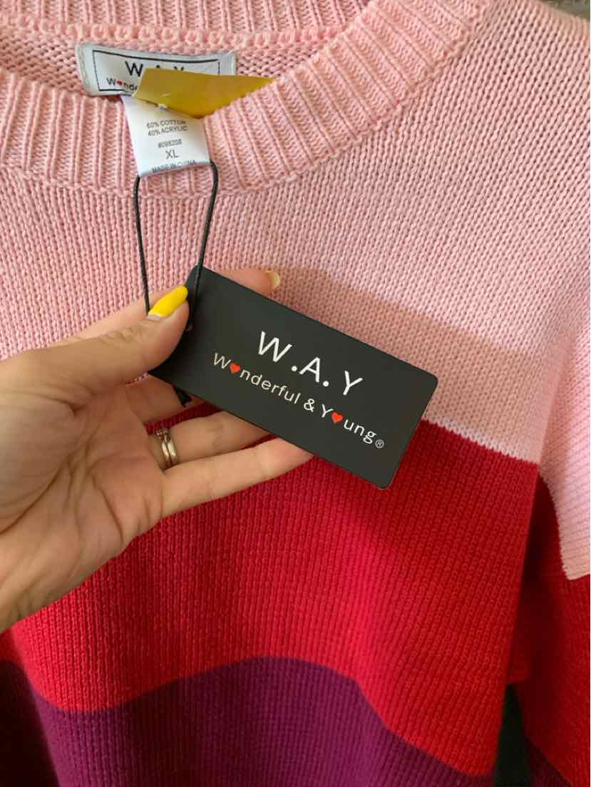 Color-blocked sweater with pink, red, and purple horizontal stripes and crew neckline.