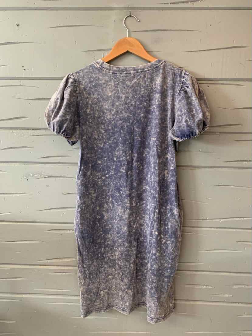 Short sleeve tie-dyed blue dress with a relaxed fit hanging on wooden hanger.