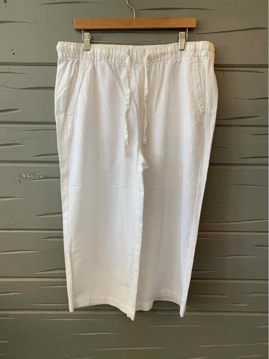 White wide-leg pants with elastic waistband and side pockets, lightweight fabric.