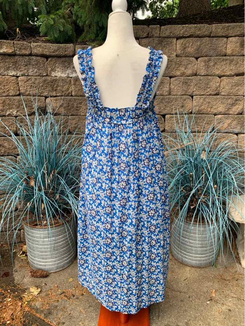 Blue floral sleeveless midi dress with ruffled straps and gathered back detail on mannequin.