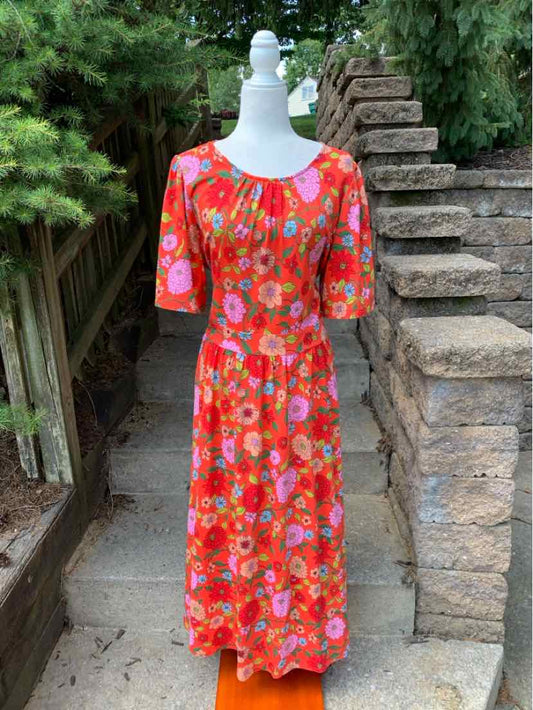 Red floral midi dress with elbow-length sleeves and a scoop neckline.