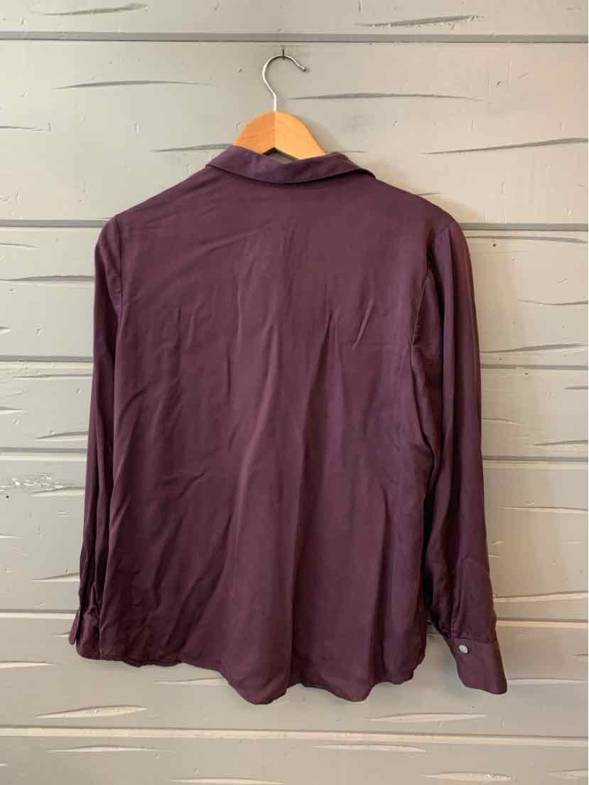 Long-sleeve dark plum blouse with a classic collar and buttoned cuffs hanging on wooden hanger.