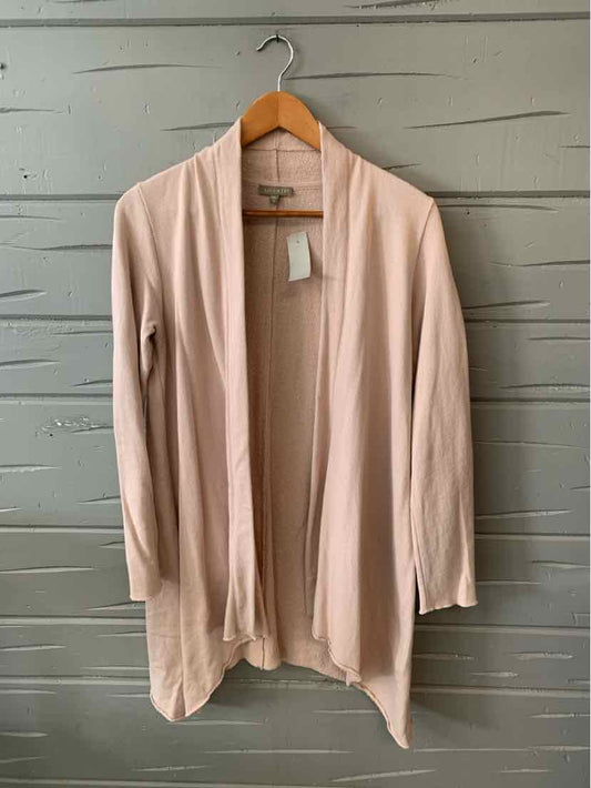 Light pink open-front cardigan with long sleeves and draped hem on wooden hanger.