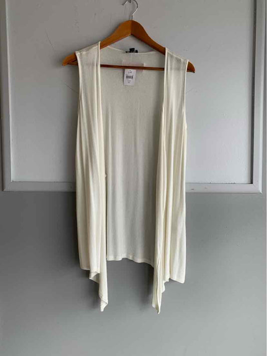 White sleeveless open-front cardigan vest with draped front panels hanging on wooden hanger.