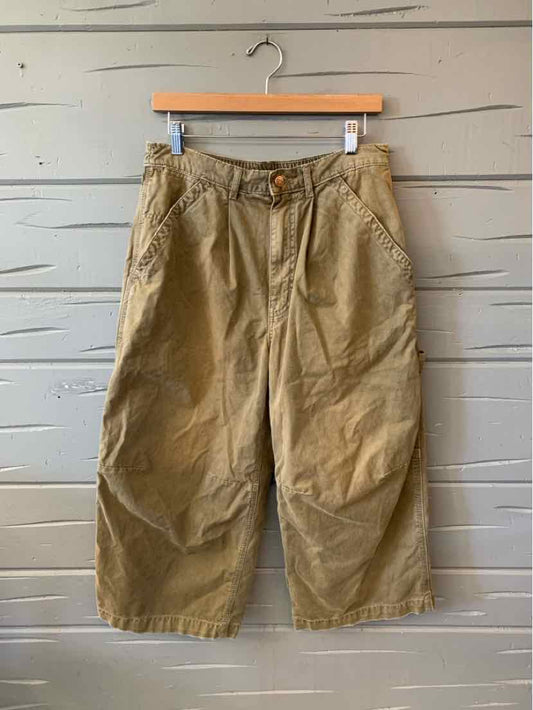 Olive-khaki cropped cargo pants with a button waist, belt loops, and large side pockets.