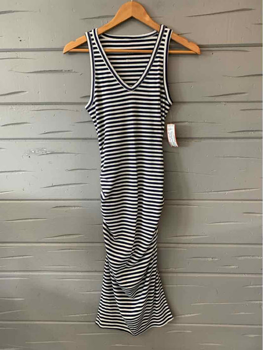 Black and white striped sleeveless midi dress with V-neck and ruched sides on hanger.