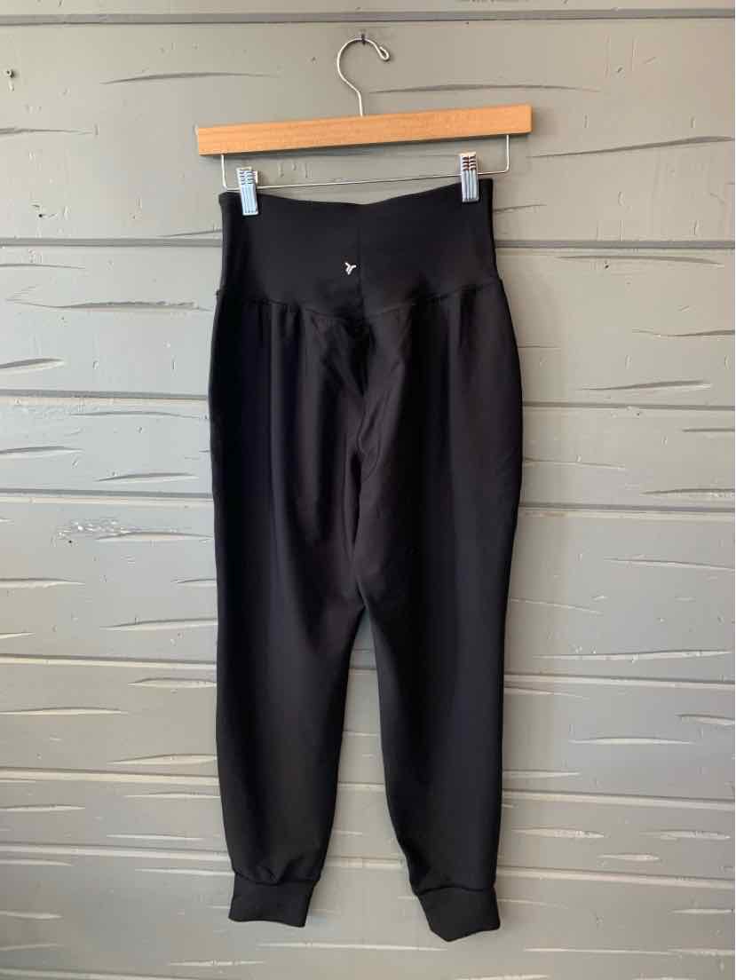 Black Old Navy women’s jogger pants with a high elastic waistband, tapered legs, and ribbed cuffs.