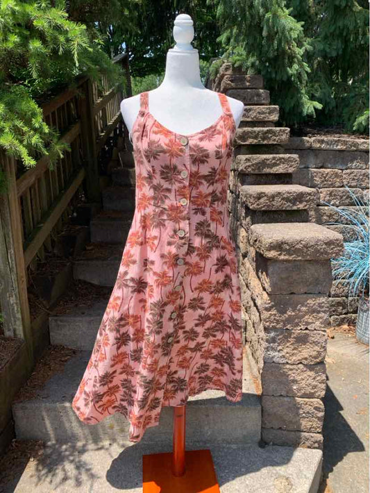 Pink tropical print sleeveless A-line dress with scoop neckline on mannequin.