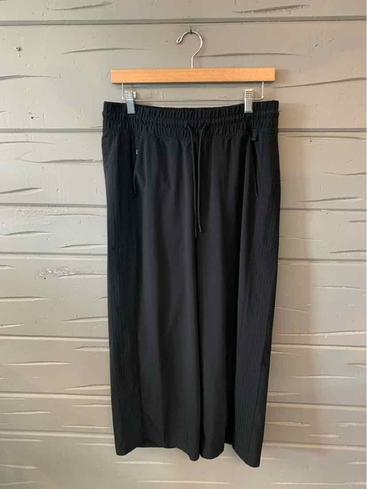 Black wide-leg pants with elastic waistband and side pockets, lightweight fabric.