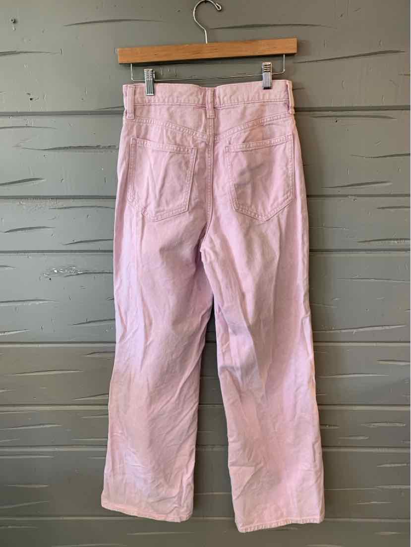 Lavender wide-leg denim pants with back pockets and belt loops, size 0, hanging on wooden hanger.