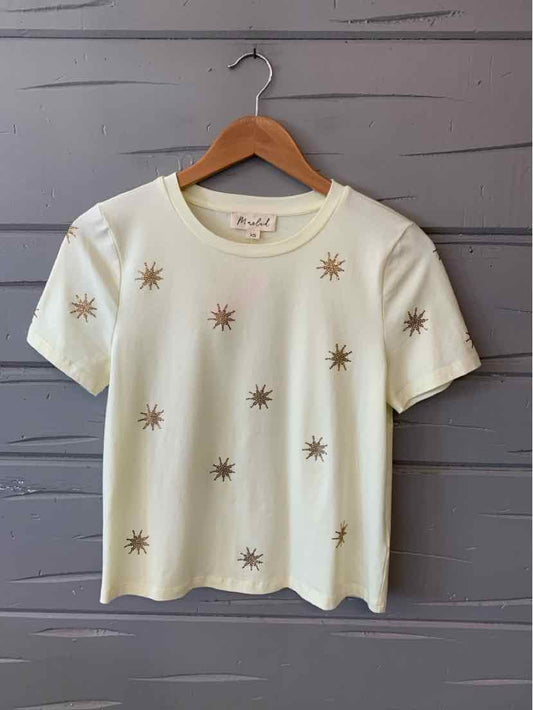 Cream short-sleeve t-shirt with small embroidered sunburst bead designs scattered across front.
