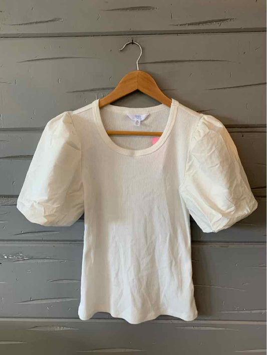 White short-sleeve top with puffed sleeves and round neckline on wooden hanger.