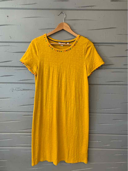 Yellow short-sleeve knee-length dress with round neckline and subtle textured fabric.