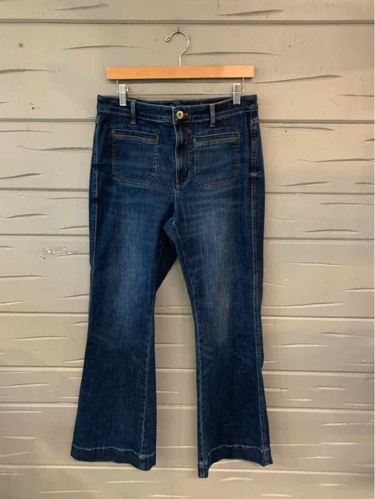 Dark blue high-waisted jeans with slight flare leg and button fly closure.