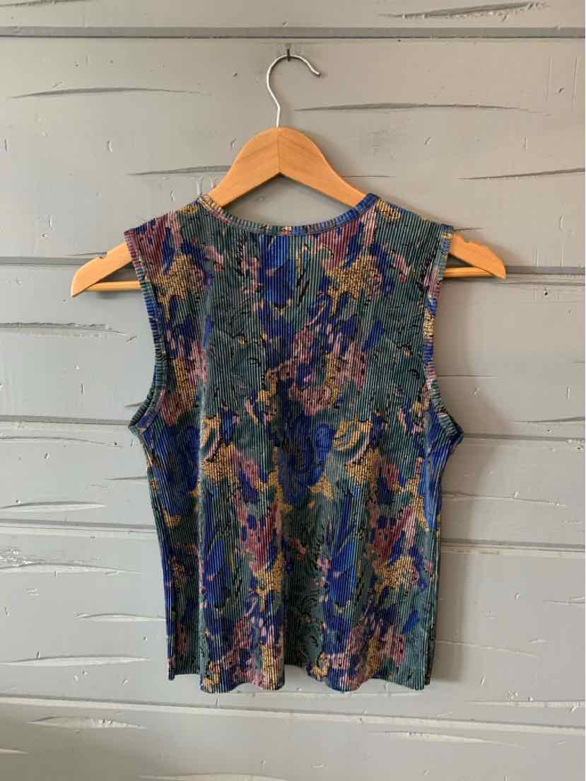 Sleeveless blouse with textured pleats in dark blue, green, and brown floral pattern.