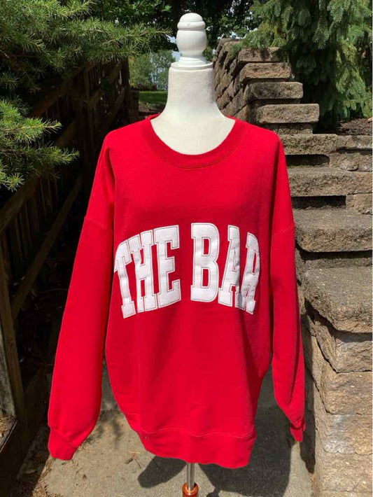 Red oversized crewneck sweatshirt with white bold "THE BAR" text across the chest, size XXL.