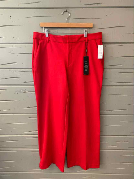 Bright red straight-leg trousers with front pockets and belt loops, size 14, hanging on wooden hanger.