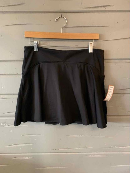 Black Old Navy athletic skirt with flared hem and comfortable waistband hanging on wooden hanger.