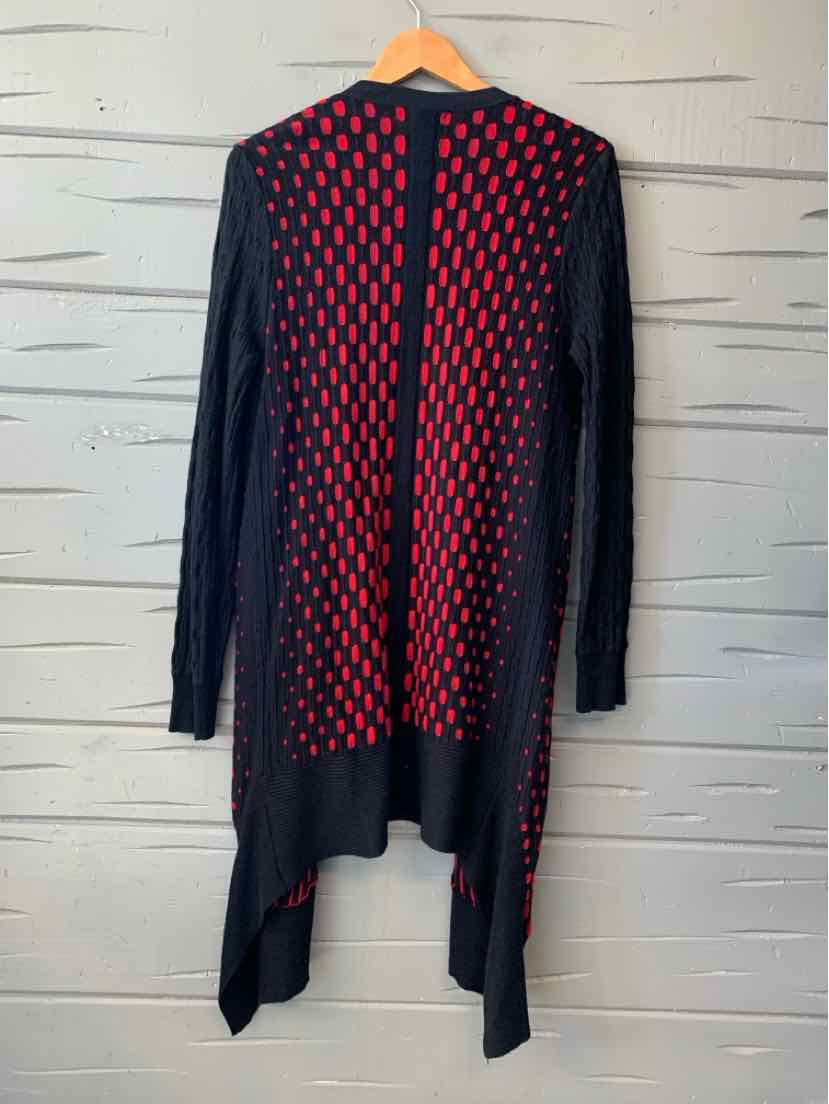 Long black knit cardigan with red diamond pattern, open front, long sleeves, and asymmetrical hem.