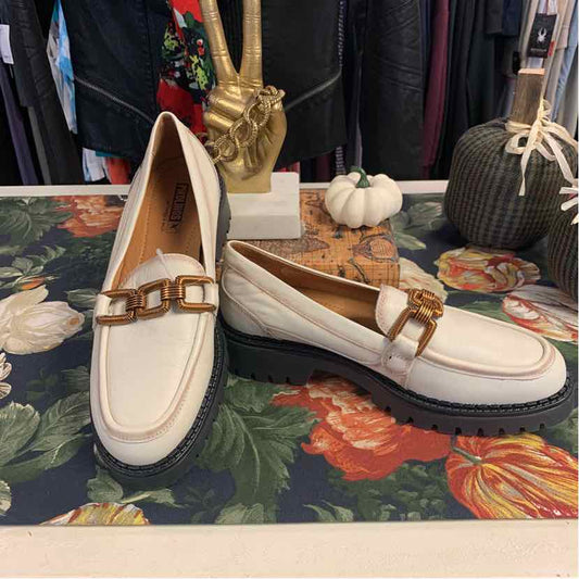 Cream leather loafers with gold chain detail, chunky black sole, perfect for casual tops and denim jeans.