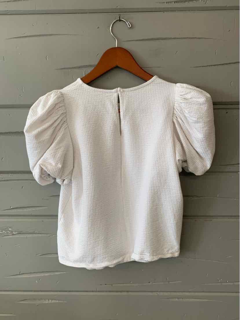 White short-sleeve blouse with puffed sleeves and a small back keyhole button closure.
