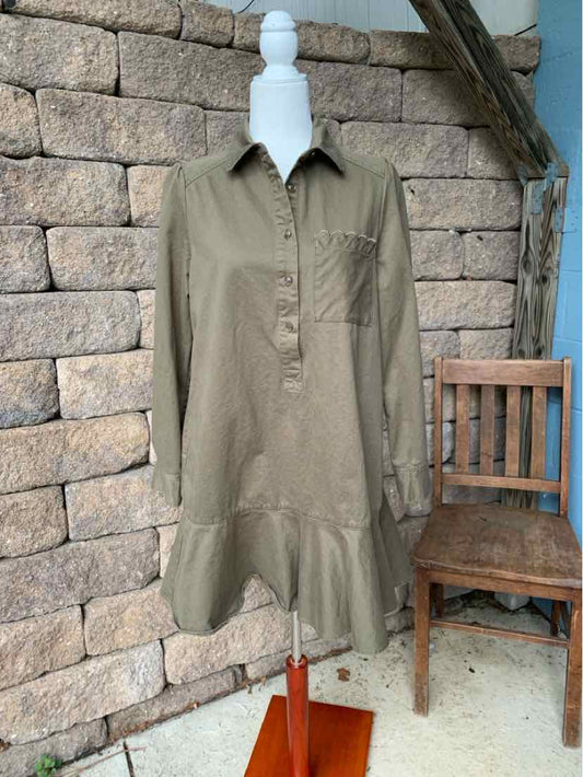 Olive green long-sleeve shirt dress with collar, front chest pocket, and tiered ruffle hem.