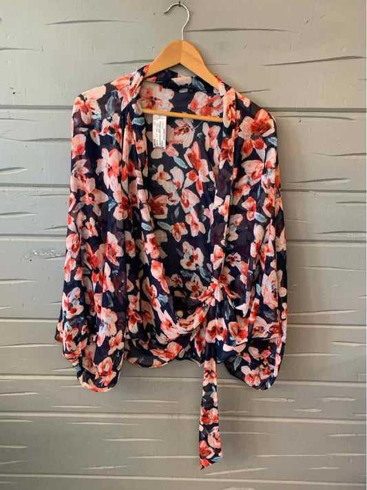 Navy blue floral wrap blouse with pink and white flower print, long sleeves, and tie waist.