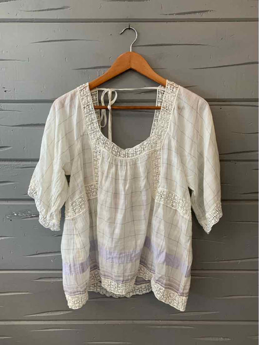 White lightweight blouse with puff sleeves, lace trim neckline, and subtle plaid pattern.