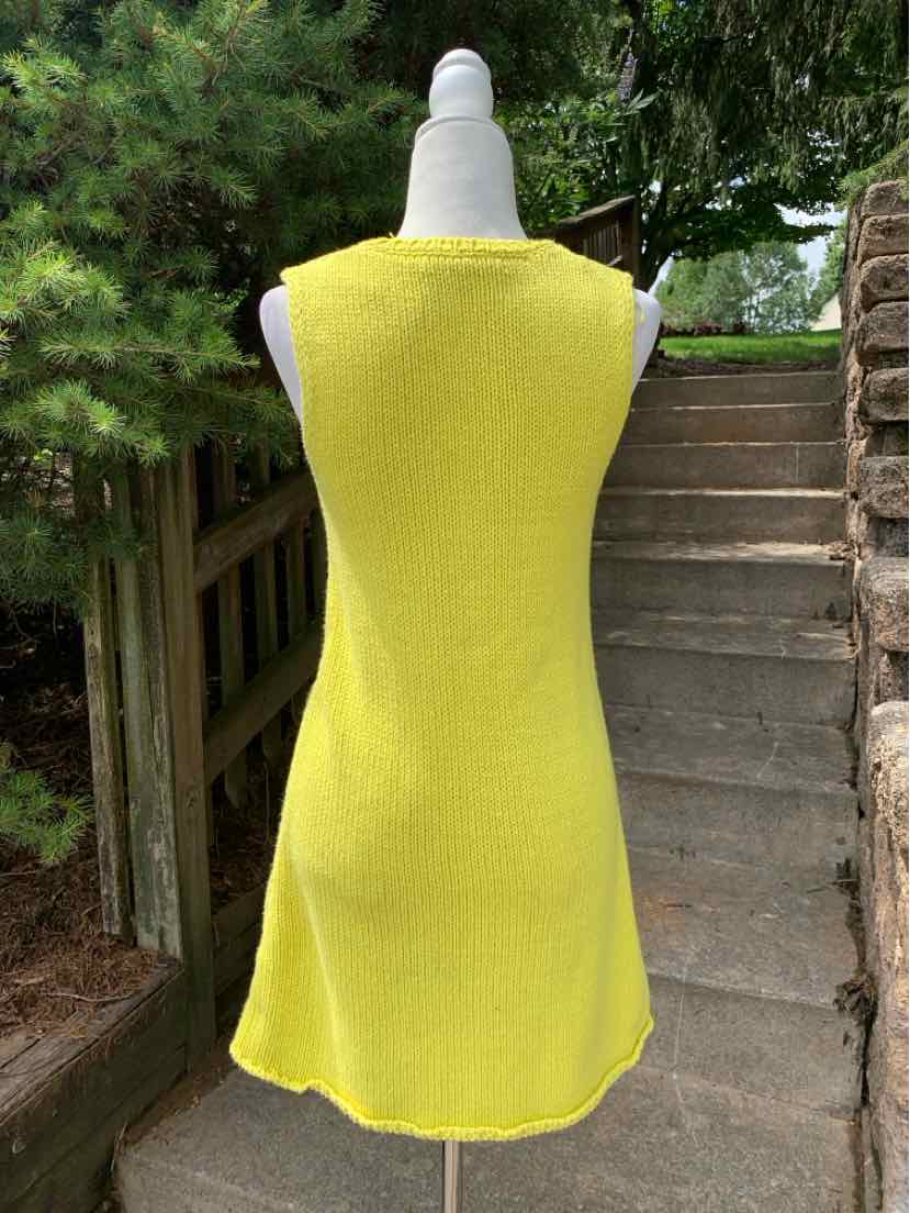 Sleeveless yellow A-line dress with a simple back and soft fabric texture.