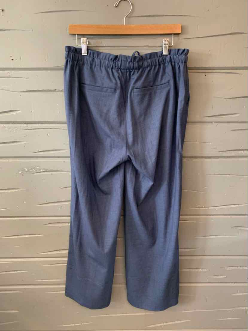 Navy blue casual pants with elastic waistband and straight legs hanging on wooden hanger.