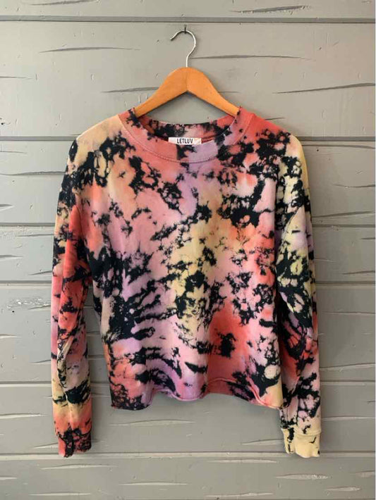 Tie-dyed women's casual top in peach, black, and cream with long sleeves and crew neck.